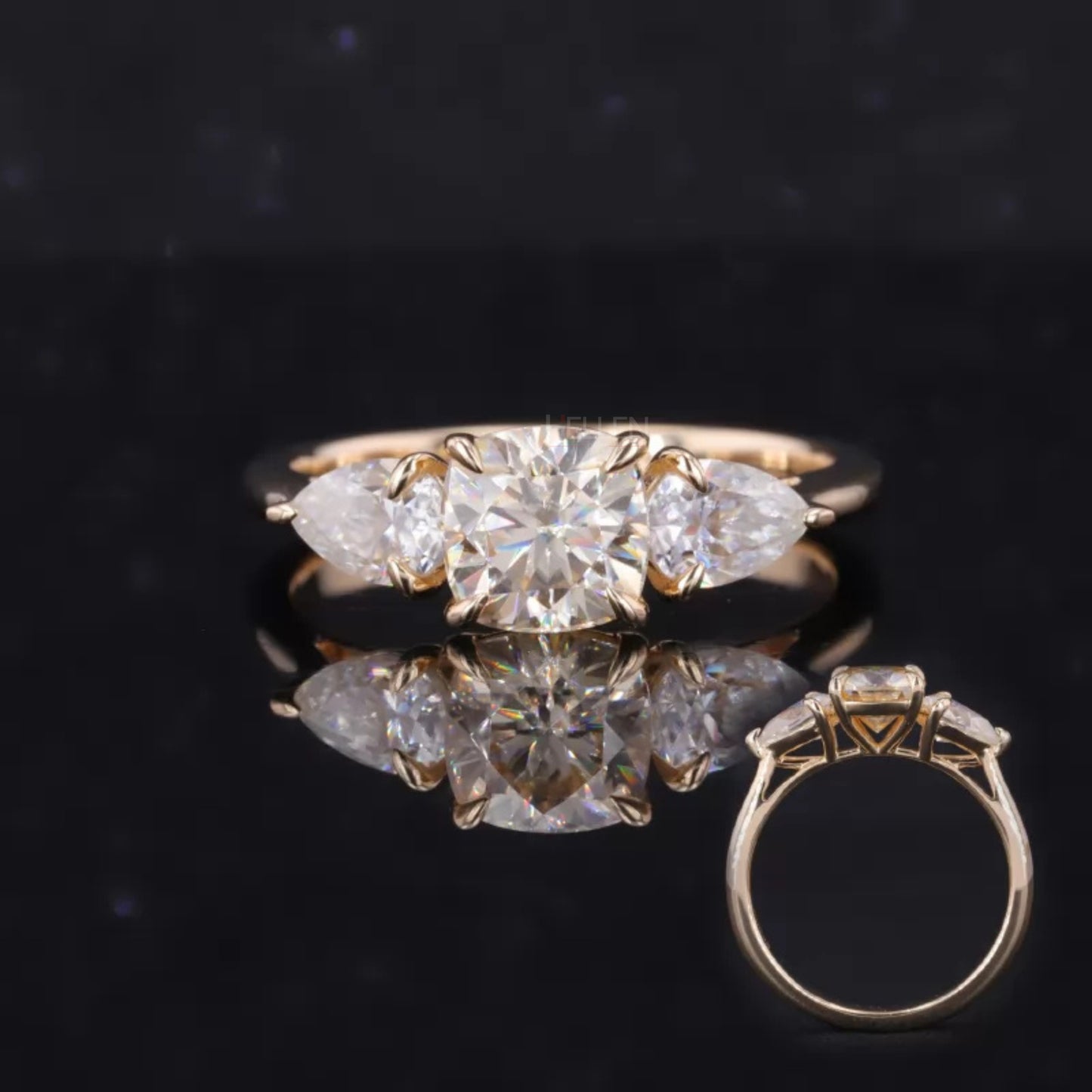 Cushion cut center with pear side moissanite stones – sophisticated and romantic three-stone engagement ring