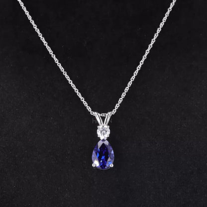 Elegant drop necklace with pear cut blue tanzanite and round moissanite – vibrant gemstone jewelry for special occasions

