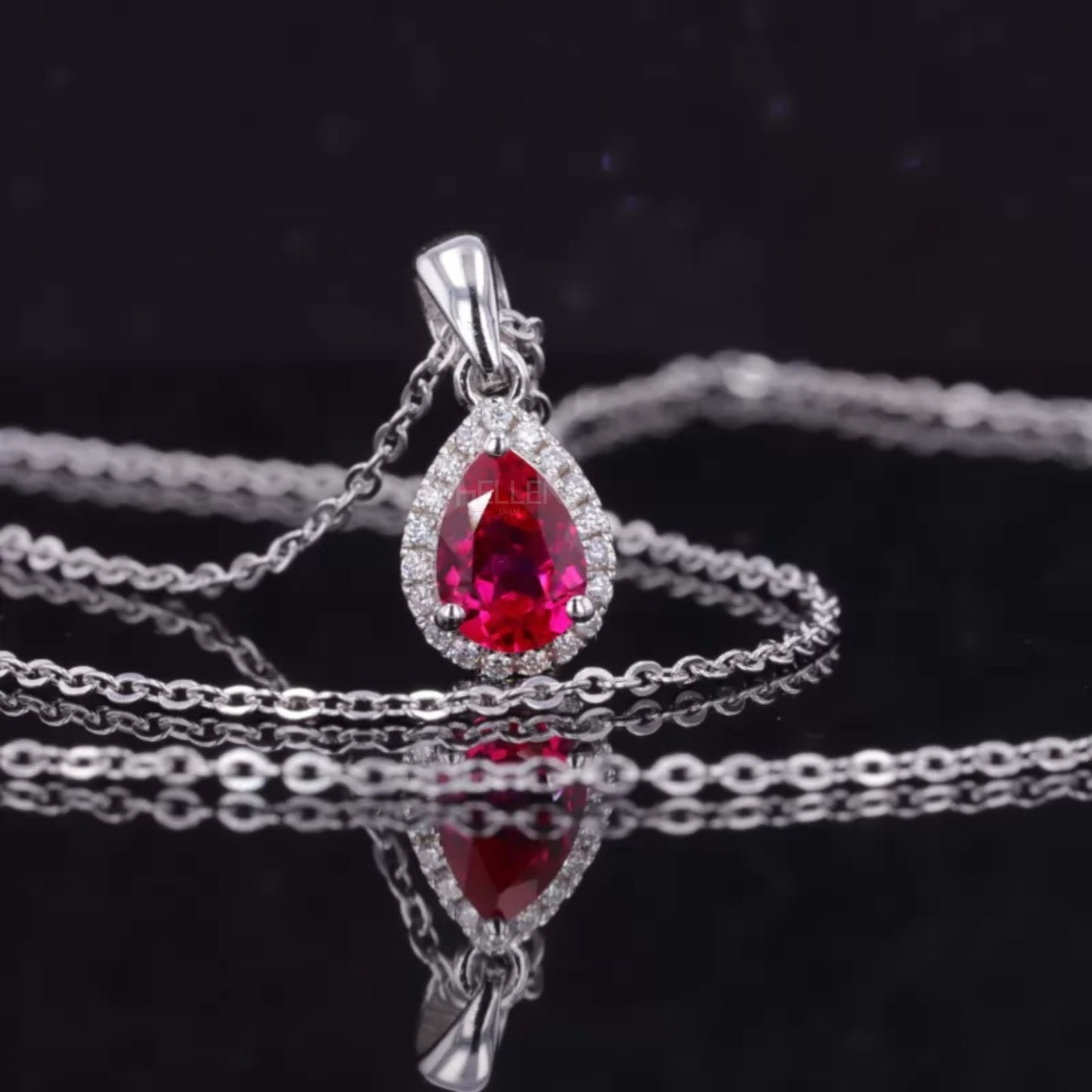 Halo pendant necklace featuring pink pear cut ruby and colorless moissanite – vibrant and luxurious gemstone design

