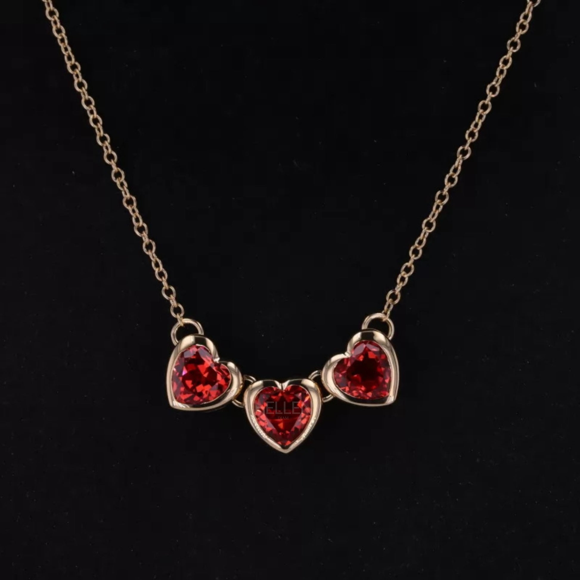 Three stone linking necklace with deep red ruby gemstones – bold and elegant jewelry design