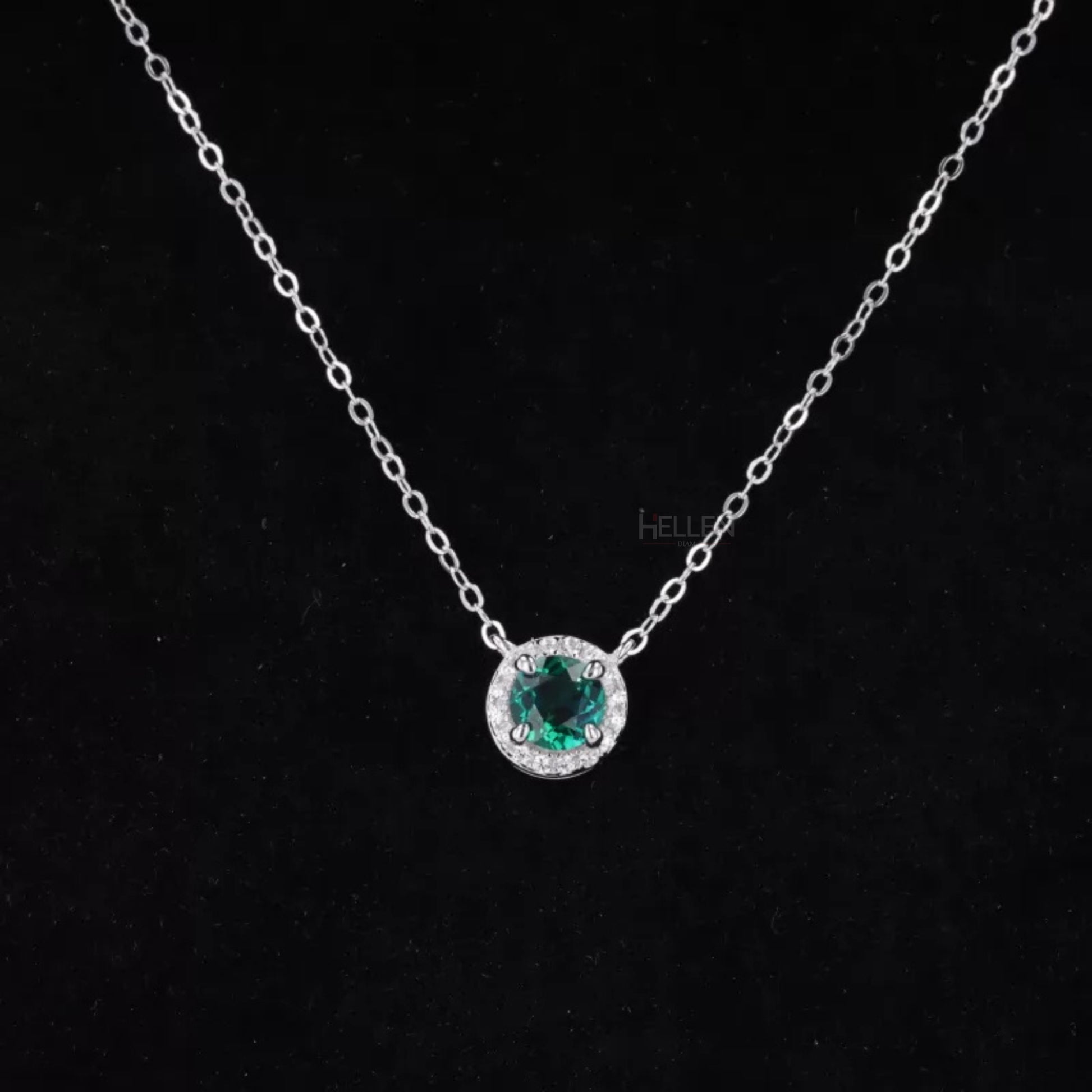 Green emerald center with moissanite halo in round pendant – classic sparkle with a pop of color

