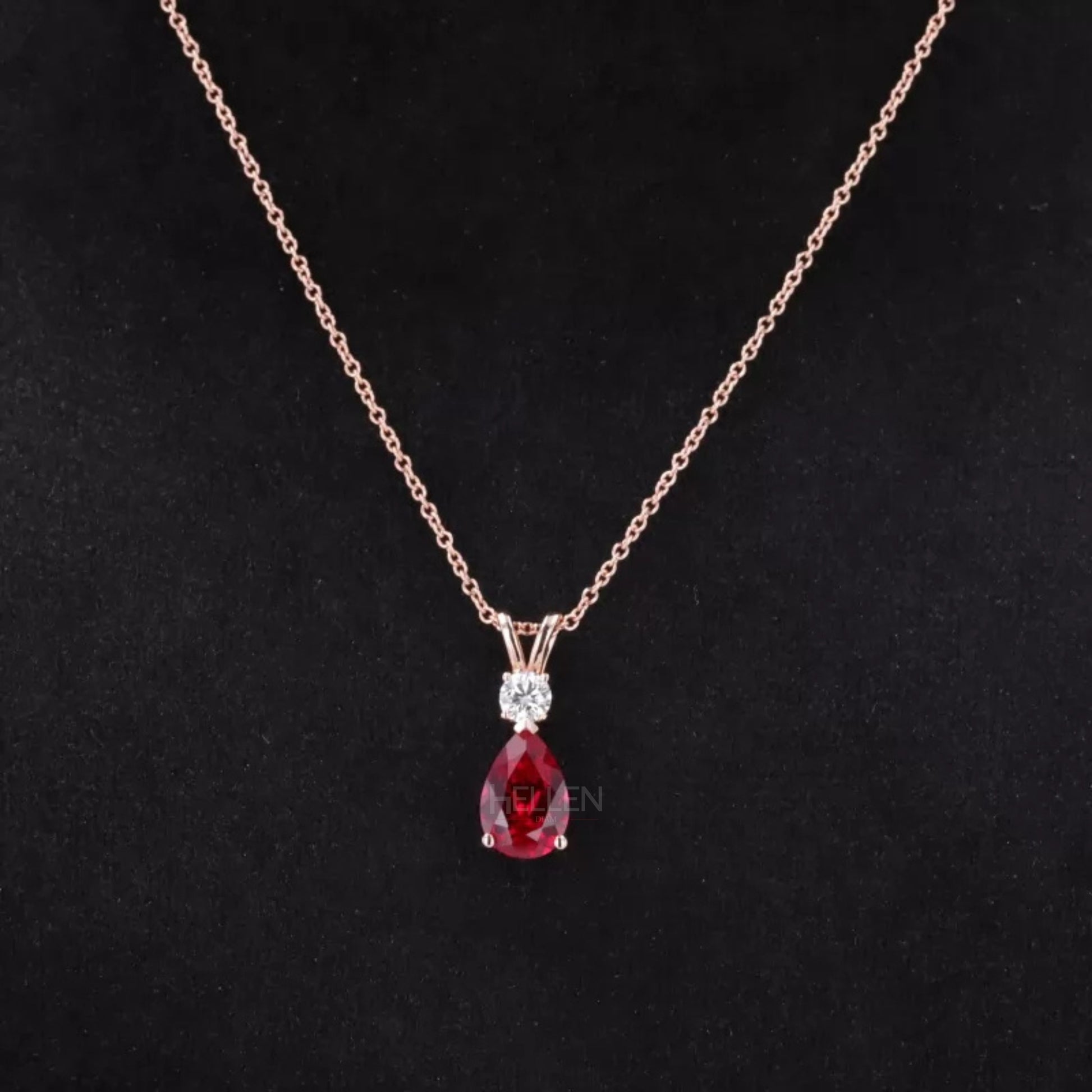 Dazzling red ruby drop necklace with pear cut center and round moissanite accents – bold and elegant design