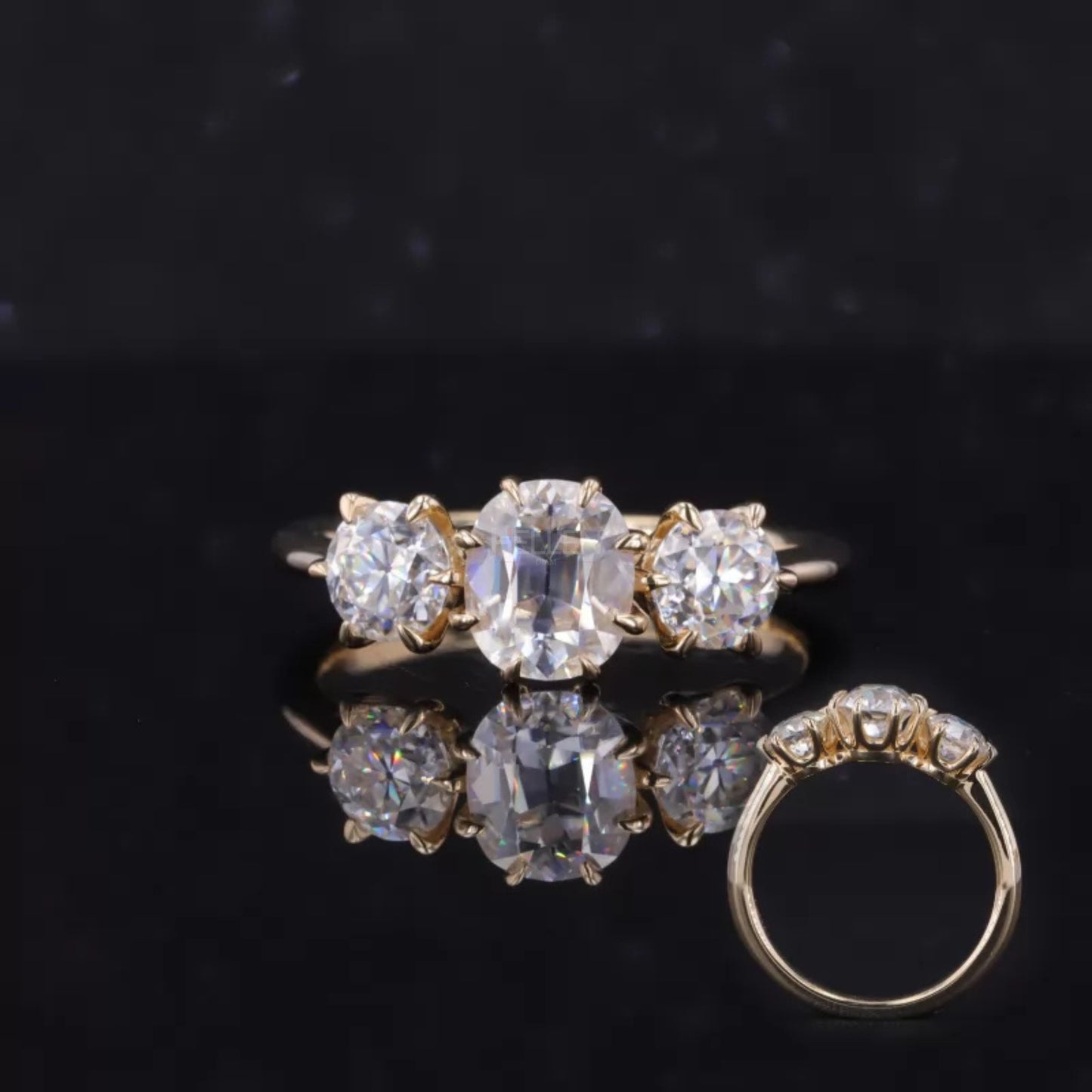 Three-stone engagement ring with oval cut center and round side moissanite – balanced sparkle and charm

