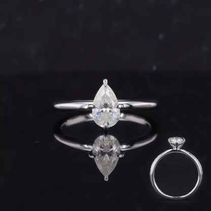 Pear cut moissanite solitaire ring with bold tiger prong setting – statement engagement ring with modern elegance