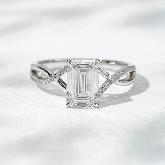 Emerald gemstone solitaire wedding ring with crossed shank – elegant and symbolic bridal design