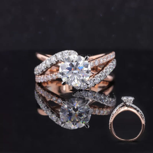 Solitaire moissanite ring with round cut center and diamonds on split shank – graceful and sparkling bridal design