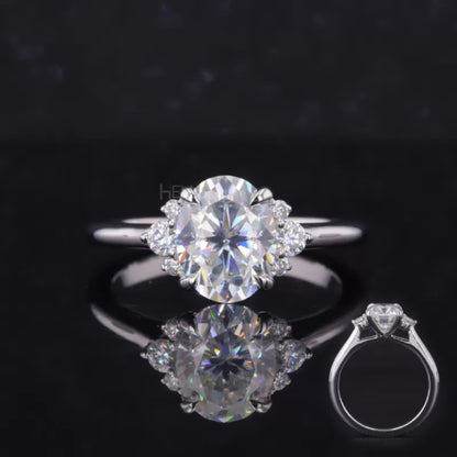 Floral illusion proposal ring with oval cut moissanite center and round side stones – blooming sparkle and charm