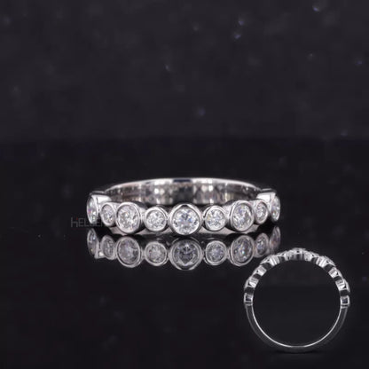 Sterling silver anniversary band with round cut moissanite in bezel setting – sleek and secure brilliance

