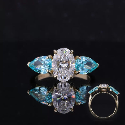 Aquamarine ring with pear and oval cut moissanite – vibrant gemstone engagement ring with graceful mix of shapes