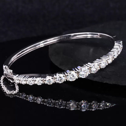 Round cut moissanite bangle bracelet with secure chain lock – refined sparkle with added safety and style

