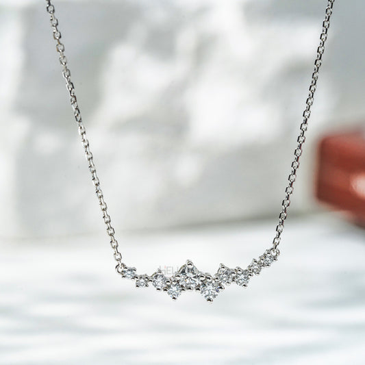 Layered necklace with uneven round moissanite stones on an anker chain – modern and stylish everyday jewelry