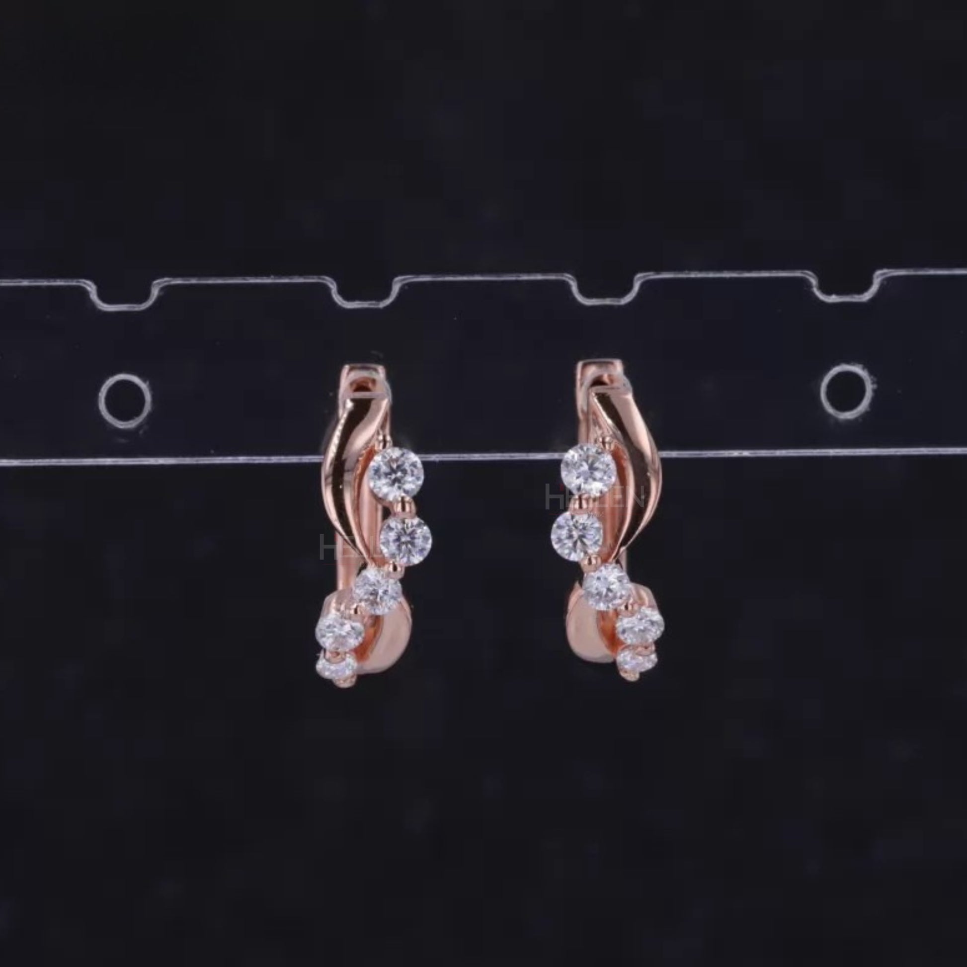 Wavy huggie hoops featuring five round cut moissanite stones – elegant curves and dazzling brilliance

